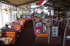 the inside of a restaurant with orange and pink booths