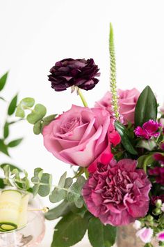 a vase filled with pink and purple flowers