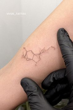 a tattoo on the leg of a woman with black gloves and rubber gloves around her legs