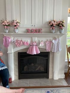 Baby Shower for Baby Rose. Mantle Decorations. Clothes garland were gifts from the hostess. Baby Shower Fireplace Mantle, Baby Clothes Baby Shower Decor, Baby Shower Staircase Decor, Onsie Garland Decoration, Baby Clothes Garland, Clothesline Baby Shower Decor