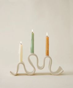 three lit candles sitting next to each other