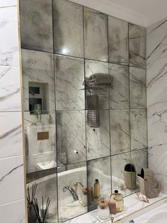 a bathroom with marble tiles on the wall