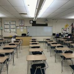 an empty classroom with desks and chairs