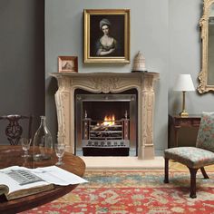 a living room filled with furniture and a fire place next to a painting on the wall