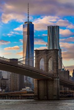 the brooklyn bridge and lower manhattan skyline at sunset