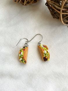 a pair of taco earrings sitting on top of a table