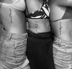 three women with cross tattoos on their stomachs