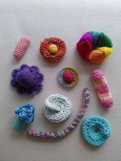 crocheted objects are arranged in the shape of a smiley face on a white surface