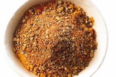 a white bowl filled with spices on top of a table