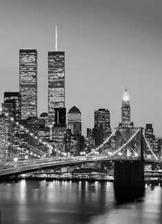 black and white photograph of the brooklyn bridge in new york city, ny at night