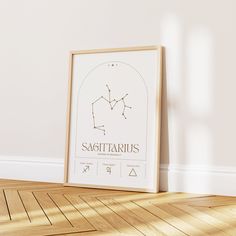 the sagittarius zodiac sign is displayed in front of a white wall and wooden floor