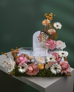 an arrangement of flowers on top of a table