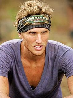 a man wearing a bandana and holding a tennis racquet in his hand