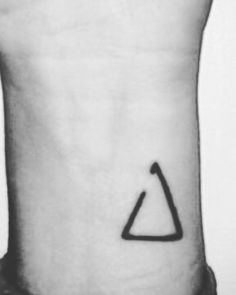 a black and white photo of a triangle tattoo