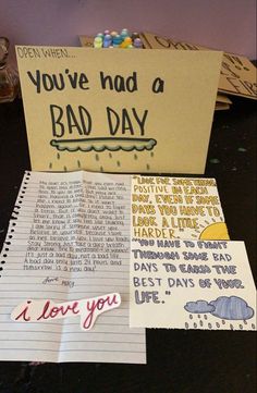 two note cards with writing on them next to an open notebook that says, you've had a bad day