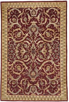 a red and gold rug with an ornate design