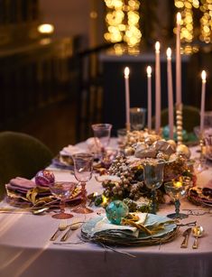 the table is set with candles and dishes