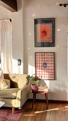 a living room filled with furniture and pictures on the wall