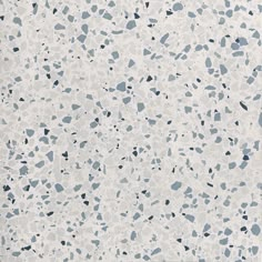 a white and blue speckled wallpaper with black dots on the bottom right corner