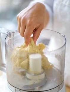 someone is using a food processor to make something