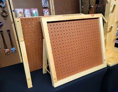 two wooden pegboard boards are on display