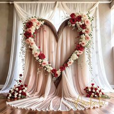 two hearts made out of flowers are on display in front of a curtained window