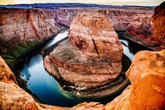 a river in the middle of a canyon surrounded by rocks and cliffs with water running through it