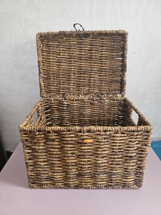 This vintage wicker basket is a charming addition to any home. Perfect for picnics, storage, or as a decorative item, it is 10 inches high, 14 inches long, and 10 inches wide. The basket features a classic rectangular shape and a warm brown color that complements a variety of decor styles. With a sturdy handle, this medium-sized storage basket is ideal for holding all sorts of items. Its 1980s style and year of manufacture add a touch of nostalgia to any space. Whether you use it to store blankets, magazines, or as a centerpiece at your next gathering, this wicker basket is sure to impress. Store Blankets, Warm Brown Color, Vintage Wicker Baskets, 1980s Style, Vintage Wicker, Wicker Basket, Warm Brown, Storage Basket, Wicker Baskets