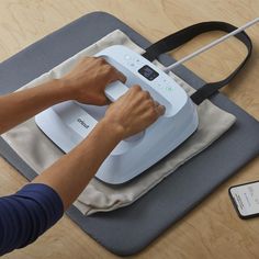 a person is using an electric device on a mat