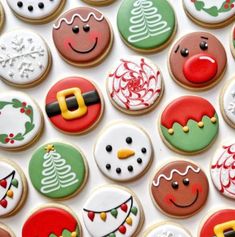 decorated christmas cookies are arranged on a white surface