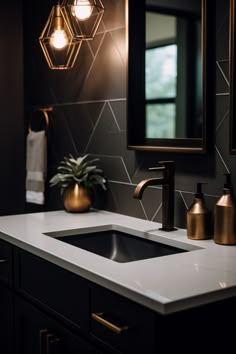 a bathroom sink with gold faucets and lights above it, next to a mirror