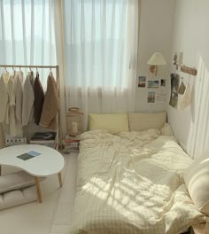 a bed sitting in a bedroom next to a window