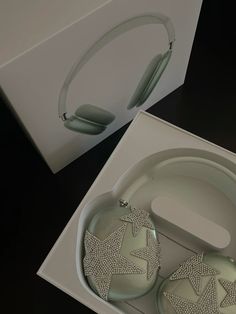 two white headphones sitting inside of a box