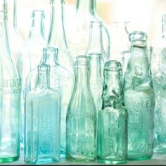 there are many empty glass bottles lined up