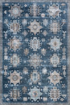 a blue rug with an intricate design on the front and back side, in various colors