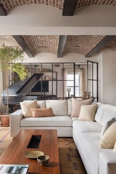 a living room filled with furniture and a piano