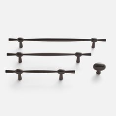 four black handles and knobs on a white background