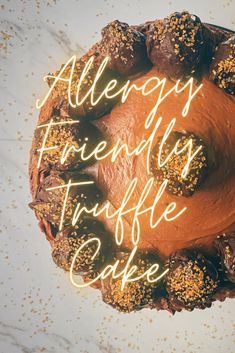 there is a cake with frosting and sprinkles on it that says, allergy friendly truffle cafe