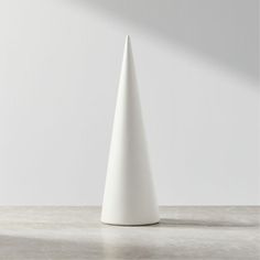 a white vase sitting on top of a table