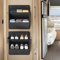 the inside of a camper with two shelves holding shoes