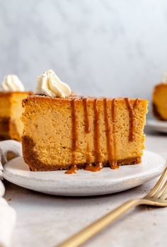 a slice of pumpkin cheesecake with caramel drizzle and whipped cream on top