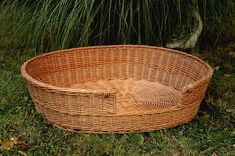 an empty wicker basket sitting in the grass