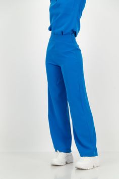 Patent Pending These high-waisted, wide-leg trousers redefine versatility, seamlessly transitioning from scrubs to office wear and smart casual effortlessly. The minimalist and elegant design adds a touch of sophistication to any ensemble. The high-waisted fit and wide-leg silhouette create a flattering and timeless lo Ciel Blue Scrubs, Medical Receptionist Outfit Scrubs, Stylish Scrubs Nurses, Comfy Work Pants, High Waist Blue Dress Pants For Office, Modern Blue Bottoms For Business Casual, Modern Wide Leg Pantsuit For Office, Modern Business Casual Blue Bottoms, Modern Blue Business Casual Bottoms