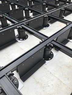 rows of black metal tables sitting on top of each other