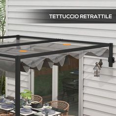 an outdoor dining area with table and chairs under the awning that reads tetuccio retratile