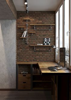 a brick wall in the corner of a room with a computer desk and bookshelf