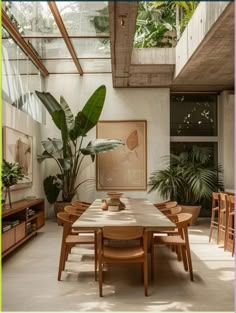 a dining room table surrounded by plants and chairs