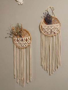 two woven wall hangings with flowers in them