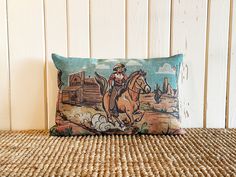 a pillow with a cowboy riding a horse on it