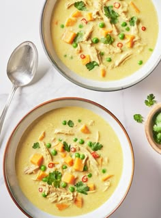 two bowls filled with soup on top of a table